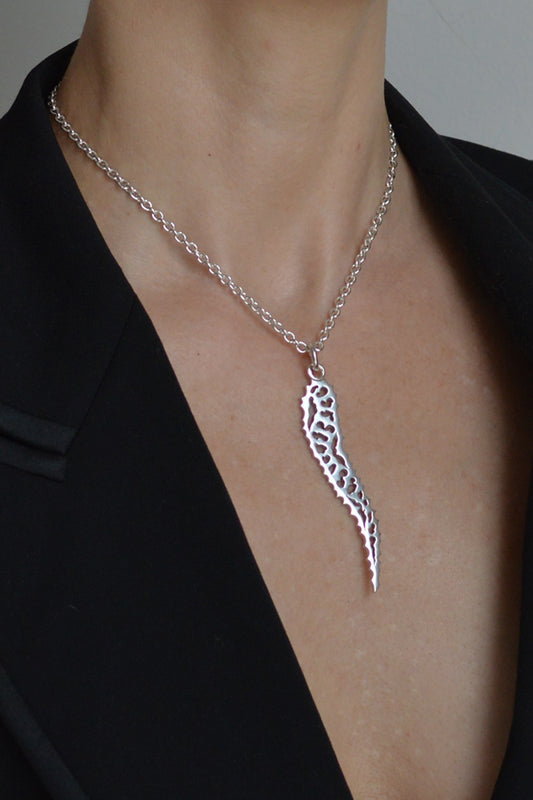 Large Patterned silver tusk pendant necklace by Annika Burman